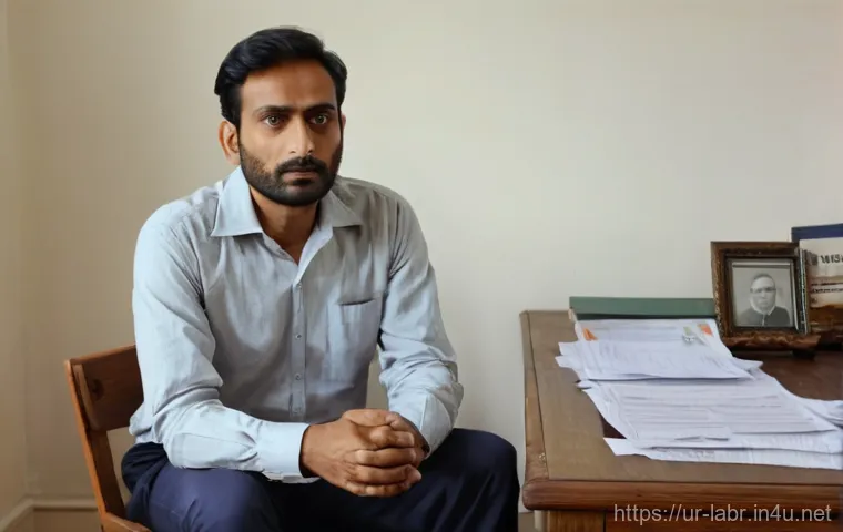 노무사 실무 케이스 분석 - A South Asian man in his late 30s, dressed in a neat but slightly worn dress shirt and trousers, sit...